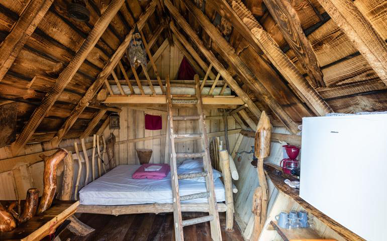 Atypical accommodation in Alsace, overview of the Witch’s wooden hut at the campsite Les Castors