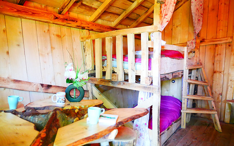 Outside view of the Wooden Hut of Gretel, rental of atypical cabins in Alsace at the Campsite Les Castors