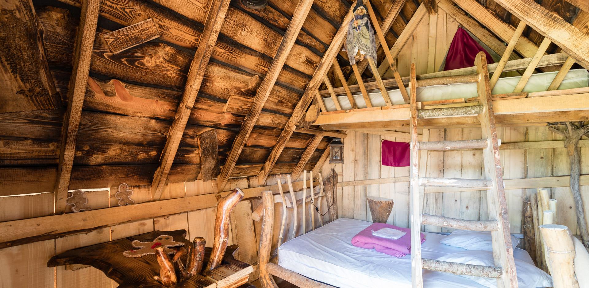 Rental of atypical accommodations near the Vosges Mountains: view of a bedroom area of a wooden cabin